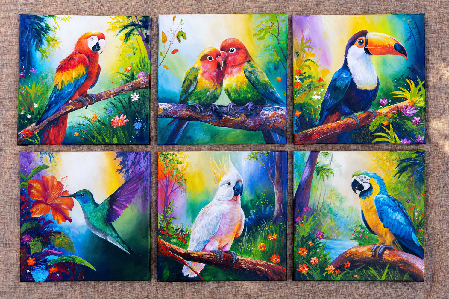 Six colourful exotic tropical birds. From left to right: scarlet macaw, lovebirds, toucan, hummingbird, cockatoo, blue and gold macaw